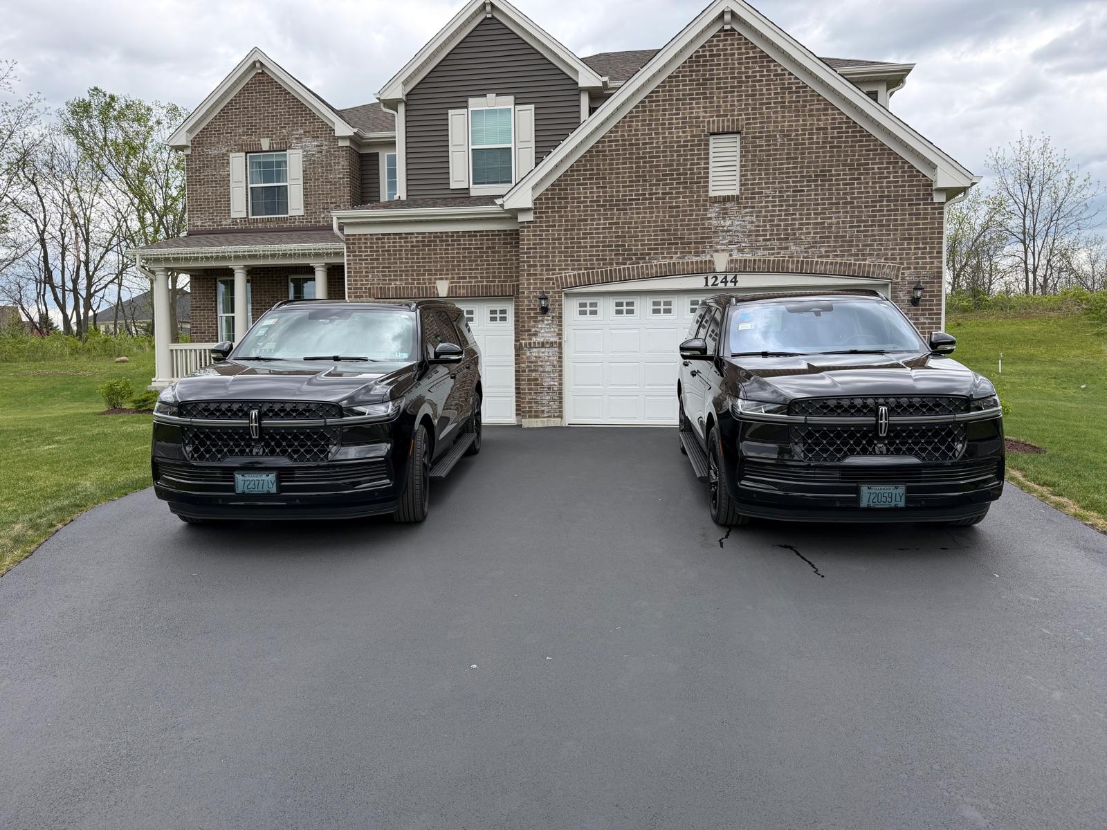 Two black Lincoln Navigator SUVs in the Elite Limo Group fleet